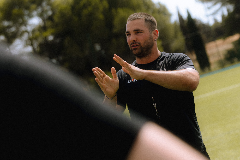 Image d'une entraîneur sportif qui donne des consignes à son équipe